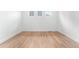 A bedroom with wood floors and three transom windows at 16517 W 92Nd Pl, Arvada, CO 80007