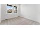 A light-filled bedroom with wall-to-wall carpet and windows overlooking a neighborhood street at 16517 W 92Nd Pl, Arvada, CO 80007