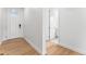 Inviting foyer features hardwood flooring, white trim, and a view of the front door and hallway to another room at 16517 W 92Nd Pl, Arvada, CO 80007