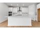 Modern kitchen island featuring quartz countertops and a stainless steel faucet at 16517 W 92Nd Pl, Arvada, CO 80007