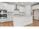 Beautiful modern kitchen featuring a large island and stainless steel appliances at 16517 W 92Nd Pl, Arvada, CO 80007