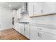 Gourmet kitchen featuring white cabinets, quartz countertops, and stainless steel appliances at 16517 W 92Nd Pl, Arvada, CO 80007