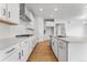 Gourmet kitchen featuring white cabinets, a subway tile backsplash, and stainless steel appliances at 16517 W 92Nd Pl, Arvada, CO 80007
