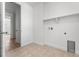Bright laundry room features tile floors, washer hookups, and white walls at 16517 W 92Nd Pl, Arvada, CO 80007