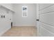 A dedicated laundry room with tiled floors, utility sink, and window at 16517 W 92Nd Pl, Arvada, CO 80007