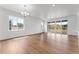 Spacious living area with hardwood floors, lots of natural light, and large windows overlooking outdoor scenery at 16517 W 92Nd Pl, Arvada, CO 80007