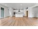 Expansive open-concept living area with hardwood floors, a kitchen island, modern lighting, and lots of natural light at 16517 W 92Nd Pl, Arvada, CO 80007