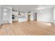 Open-concept living room with hardwood floors and seamless flow into the kitchen with modern lighting at 16517 W 92Nd Pl, Arvada, CO 80007