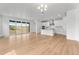 Bright and airy open-concept living space with hardwood floors, connecting kitchen, and sliding glass doors at 16517 W 92Nd Pl, Arvada, CO 80007
