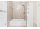 Clean bathroom with white tub, tiled walls, and a storage cabinet for towels at 3147 Vallejo St, Denver, CO 80211