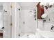Modern bathroom features a glass-enclosed shower, marble floors, and stylish vanity with wood accents at 3147 Vallejo St, Denver, CO 80211