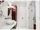 Bright bathroom showcasing a vanity with marble countertop, storage cabinet, and open doorway at 3147 Vallejo St, Denver, CO 80211
