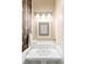 Traditional bathroom with a white sink, mirror, and stylish elephant print wallpaper at 3147 Vallejo St, Denver, CO 80211