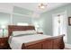 Comfortable bedroom with blue walls and a dark wood bed frame at 3147 Vallejo St, Denver, CO 80211