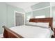 Bedroom with light blue walls, large wood bed and a closet at 3147 Vallejo St, Denver, CO 80211