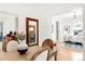 Bright dining room features wood floors, large mirror, and is open to the living room at 3147 Vallejo St, Denver, CO 80211