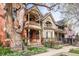 Beautiful exterior shot of a two-story home with balconies and landscaped front yard at 3147 Vallejo St, Denver, CO 80211