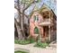 Stunning two-story house boasts classic architecture with a beautiful balcony, front garden, and a protective black metal fence at 3147 Vallejo St, Denver, CO 80211