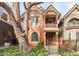 Charming two-story brick home featuring a beautiful front yard and inviting porch with vintage details at 3147 Vallejo St, Denver, CO 80211