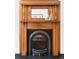 Detailed view of a fireplace featuring gorgeous woodwork and an iron grate at 3147 Vallejo St, Denver, CO 80211