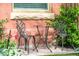 Front yard features a patio set on brick with landscaped garden including red tulips at 3147 Vallejo St, Denver, CO 80211