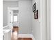 Bright hallway features freshly painted walls, hardwood floors and decor with light accents at 3147 Vallejo St, Denver, CO 80211