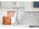Charming kitchen decor features a rolling pin, cutting boards and mosaic tile backsplash detail at 3147 Vallejo St, Denver, CO 80211