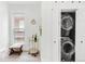 Convenient in-unit laundry area features a stacked washer and dryer, storage and natural light at 3147 Vallejo St, Denver, CO 80211