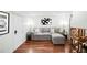 Cozy living room in finished basement has a sectional sofa, accent tables, and modern artwork at 3147 Vallejo St, Denver, CO 80211