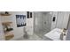 Modern renovated bathroom with a glass-enclosed shower and floating shelves at 409 N Finch Ave, Lafayette, CO 80026
