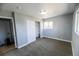 A cozy bedroom has neutral paint and flooring with a window for natural light and a closet for easy storage at 409 N Finch Ave, Lafayette, CO 80026