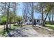 Charming single-story home with a gravel front yard, mature trees, and a welcoming walkway at 409 N Finch Ave, Lafayette, CO 80026