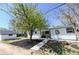 Charming home featuring black and white color palette with manicured yard and shade tree at 409 N Finch Ave, Lafayette, CO 80026