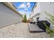 Spacious backyard with a stone patio, grill, seating, and ample gravel area at 10224 Worchester St, Commerce City, CO 80022