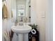 Charming powder bath with pedestal sink, modern fixtures and attractive decor at 10224 Worchester St, Commerce City, CO 80022
