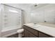 Bright bathroom featuring vanity with storage, tiled floor, and shower-tub combo at 10224 Worchester St, Commerce City, CO 80022