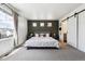 Inviting main bedroom with plush carpet, neutral paint, and a sliding barn door to en-suite bath at 10224 Worchester St, Commerce City, CO 80022