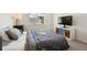 Cozy carpeted bedroom with a large window and a modern television at 10224 Worchester St, Commerce City, CO 80022