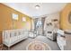 Adorable Bedroom with a crib, glider, and playful decor creating a warm and inviting atmosphere at 10224 Worchester St, Commerce City, CO 80022