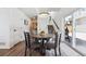 Dining area adjacent to the kitchen features a round wooden table and stairs leading to the upper level at 10224 Worchester St, Commerce City, CO 80022
