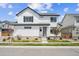Charming two-story home features a white exterior, landscaped yard, and inviting front porch for curb appeal at 10224 Worchester St, Commerce City, CO 80022