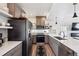 Stylish kitchen showcasing stainless steel appliances, modern cabinets, and open shelving at 10224 Worchester St, Commerce City, CO 80022