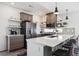 Modern kitchen features stainless steel appliances, white countertops, and bar stool seating at 10224 Worchester St, Commerce City, CO 80022