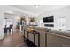 Spacious open concept living room and kitchen with luxury vinyl plank flooring and a modern fireplace at 10224 Worchester St, Commerce City, CO 80022