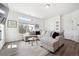 Bright living room with hardwood floors, large window, and a comfortable gray sectional sofa at 10224 Worchester St, Commerce City, CO 80022