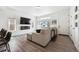 Inviting living room with a large sectional sofa, electric fireplace, and sleek design at 10224 Worchester St, Commerce City, CO 80022