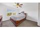 Comfortable bedroom with ceiling fan, large windows, and neutral carpet at 1522 Chimney Peak Dr, Castle Rock, CO 80109