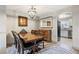 Elegant dining room with modern lighting and stylish decor adjacent to the kitchen at 1522 Chimney Peak Dr, Castle Rock, CO 80109