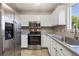 Bright kitchen featuring stainless steel appliances and updated cabinets at 1522 Chimney Peak Dr, Castle Rock, CO 80109
