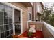 Relaxing balcony with patio furniture has views of a well-lit, modern kitchen inside at 6845 S Webster St # E, Littleton, CO 80128